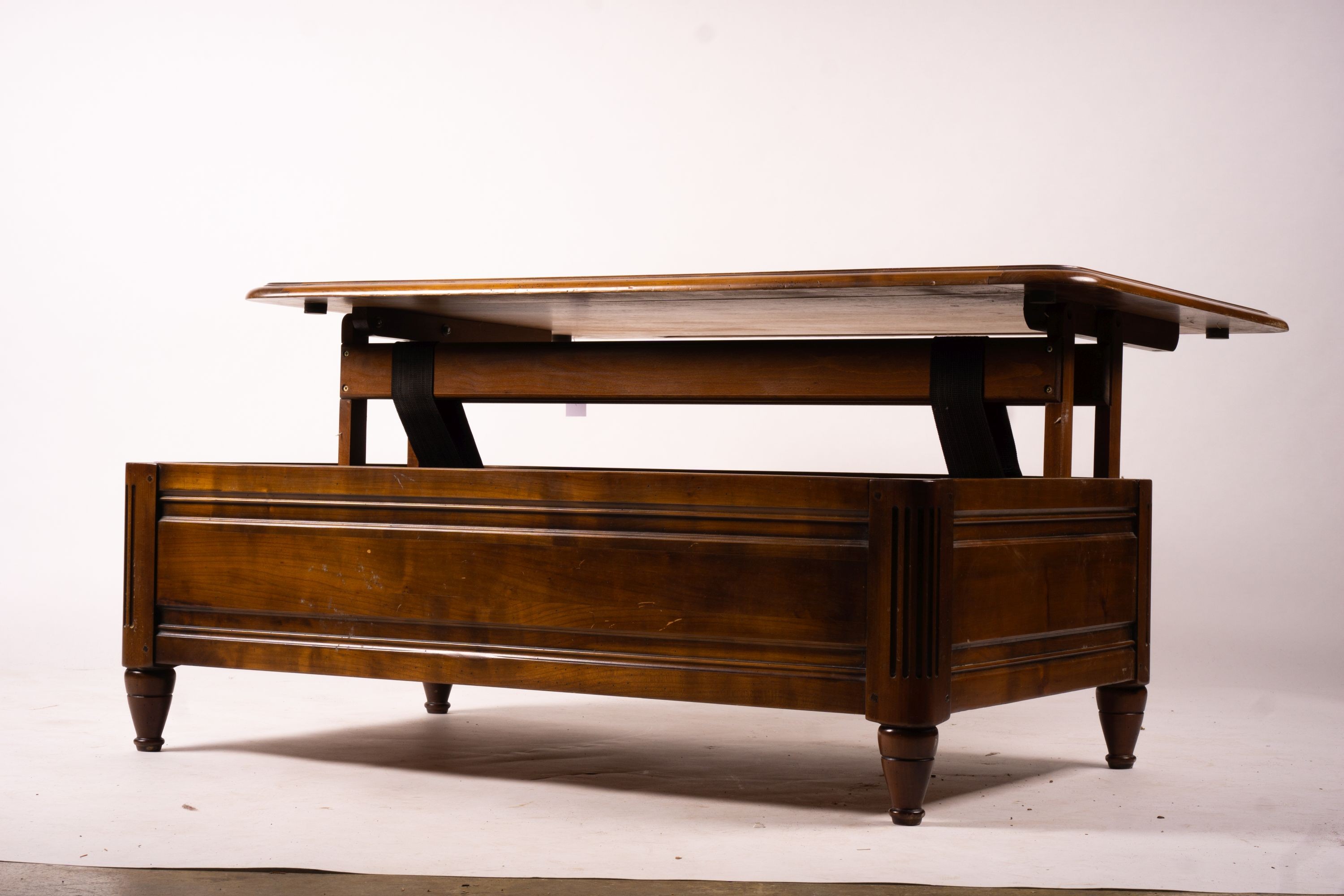 A reproduction rectangular walnut coffee table with rising top enclosing a wine bottle storage interior, length 130cm, depth 85cm, height 41cm